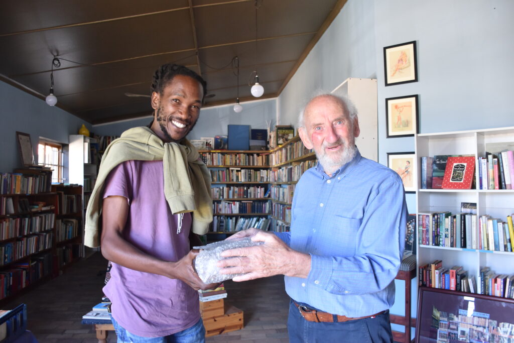 Ian Balchin handing over the archive to Buntu Duku, descendant of Dyan Tshatshu at Fables bookshop in Historic Bathurst
